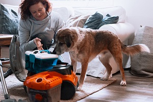 Woman and dog preparing vacuum